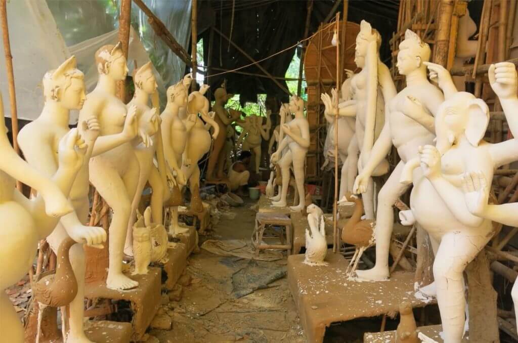 Raw and ready to be painted, idols wait in multiple rows like these in the tarp and bamboo sheds. Image ©2017 Jasmine Trails