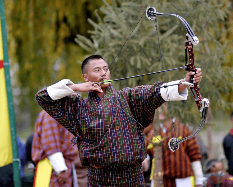 . JasmineTrails recommended tour. Kingdom in the Sky. In the image is an archer in Bhutan