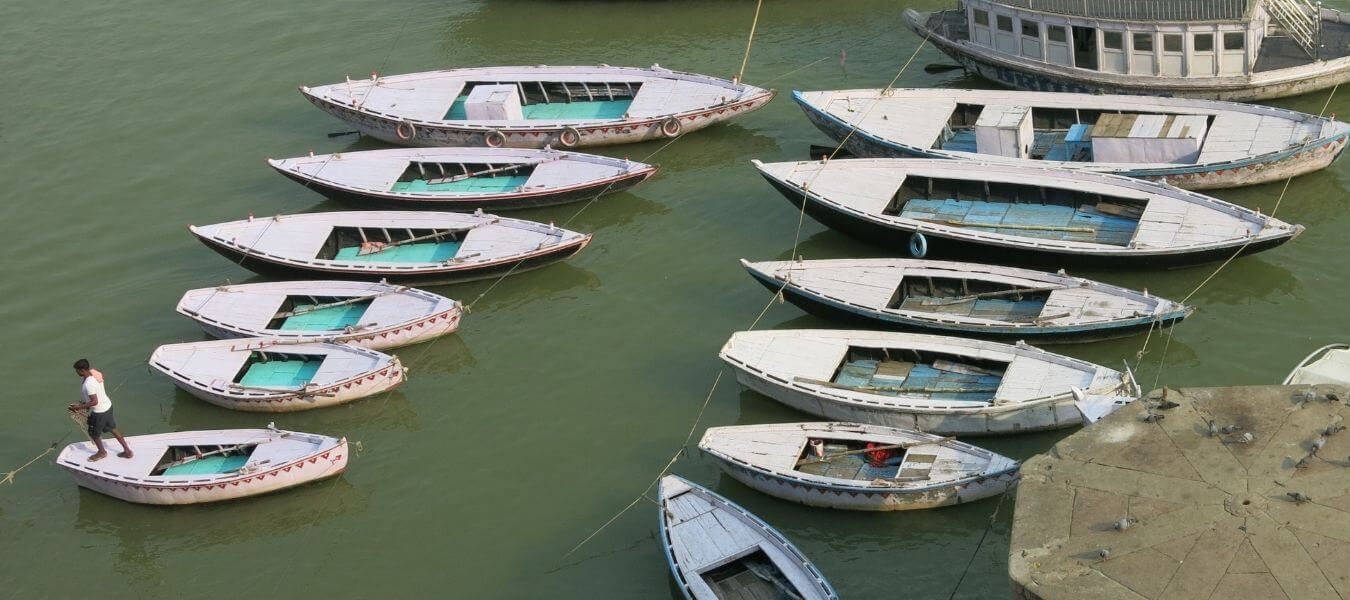 Jasmine Trails About Page Header. In the image are boats on the river Ganges in Varanasi